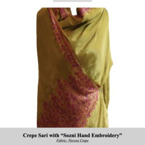 Mustard-yellow crepe sari with intricate pink Sozni embroidery along the border, draped for display (SKU H0024).